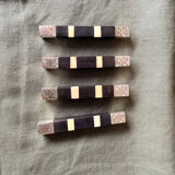 Lot 11 knife rests in ebony and silver-plated metal.