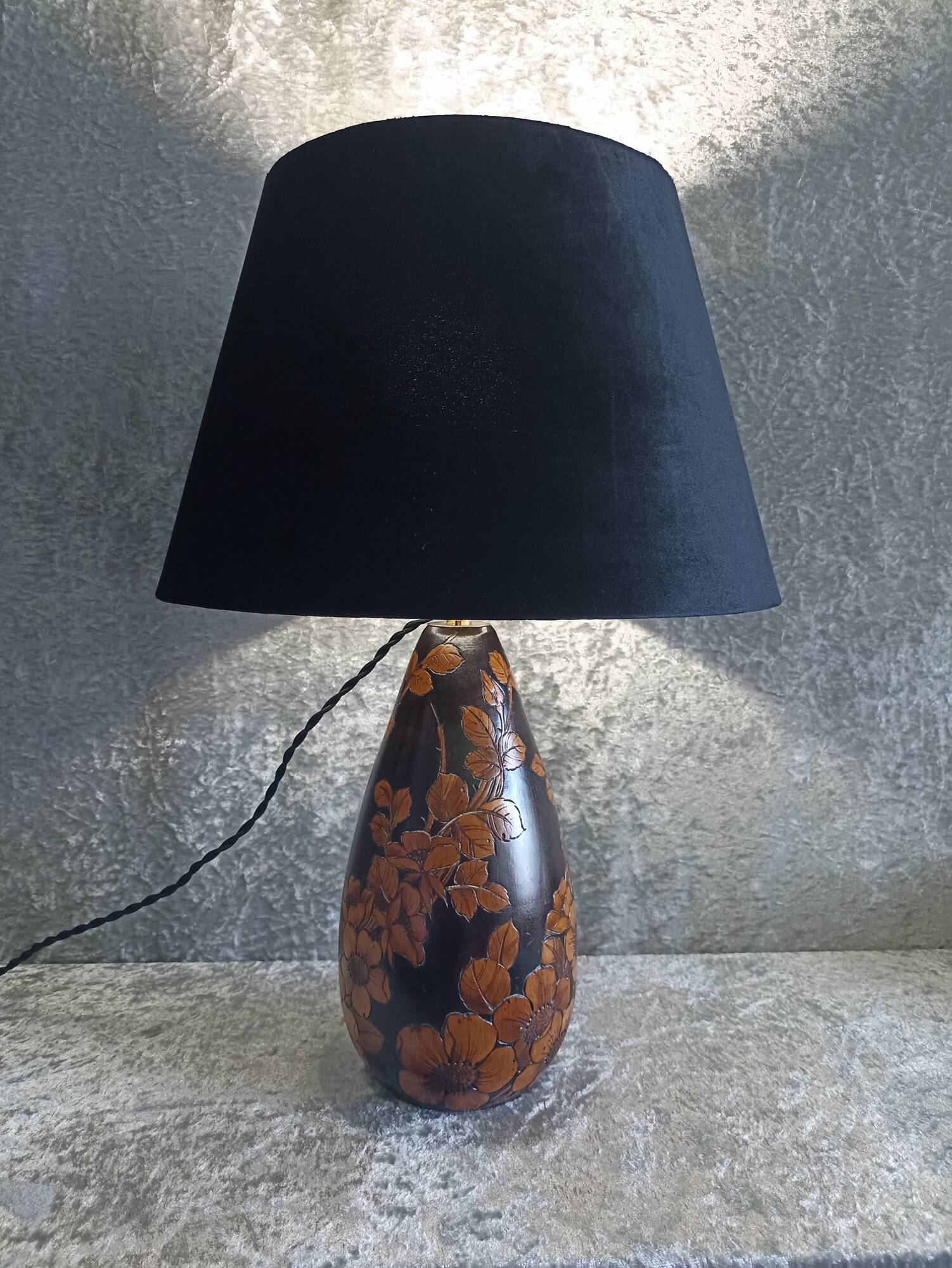 Carved wooden lamp with floral motif