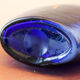 Blue blown glass vase and orange inclusion