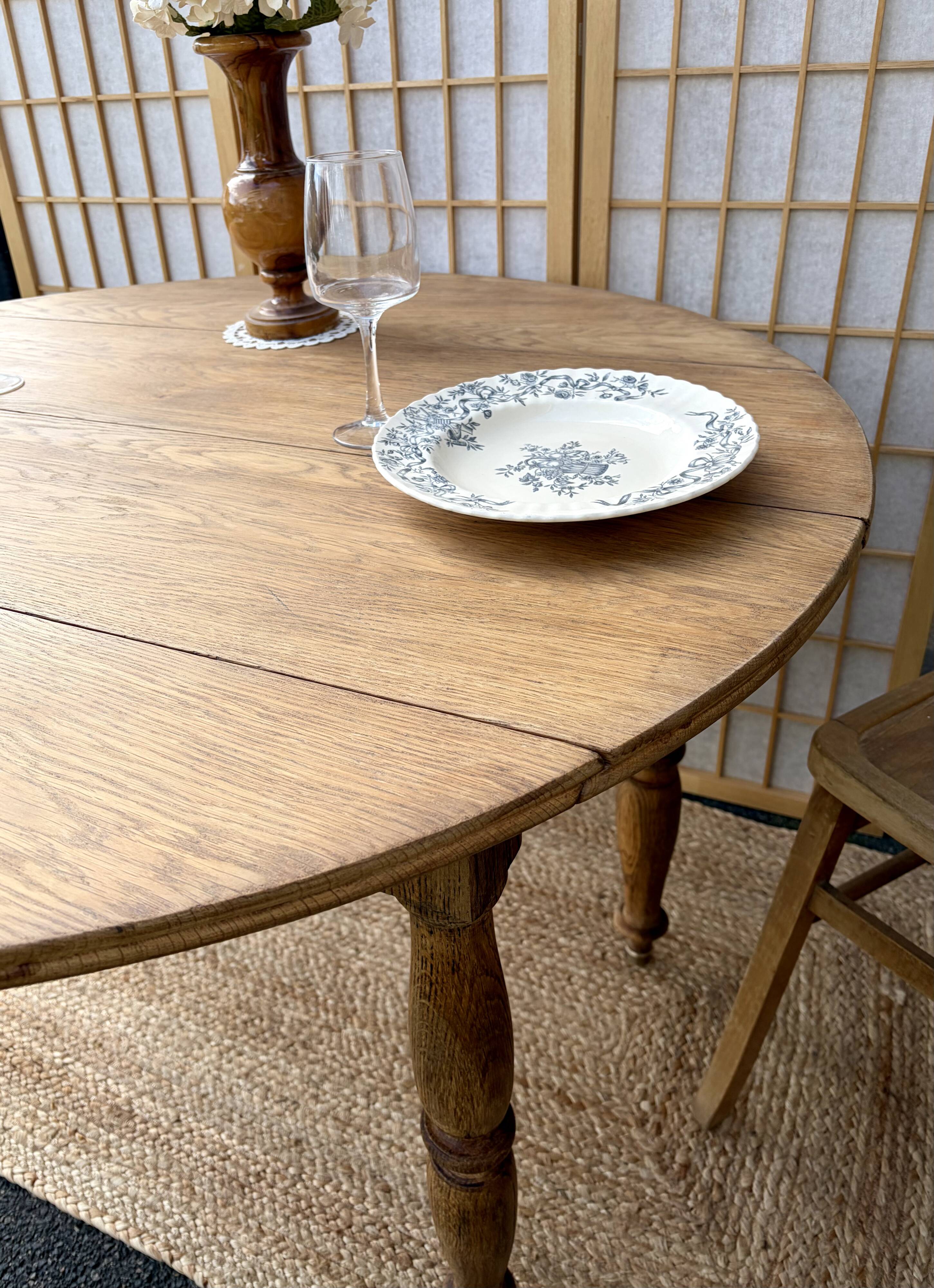 Round oak table with a drop leaf.