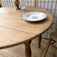 Round oak table with a drop leaf.