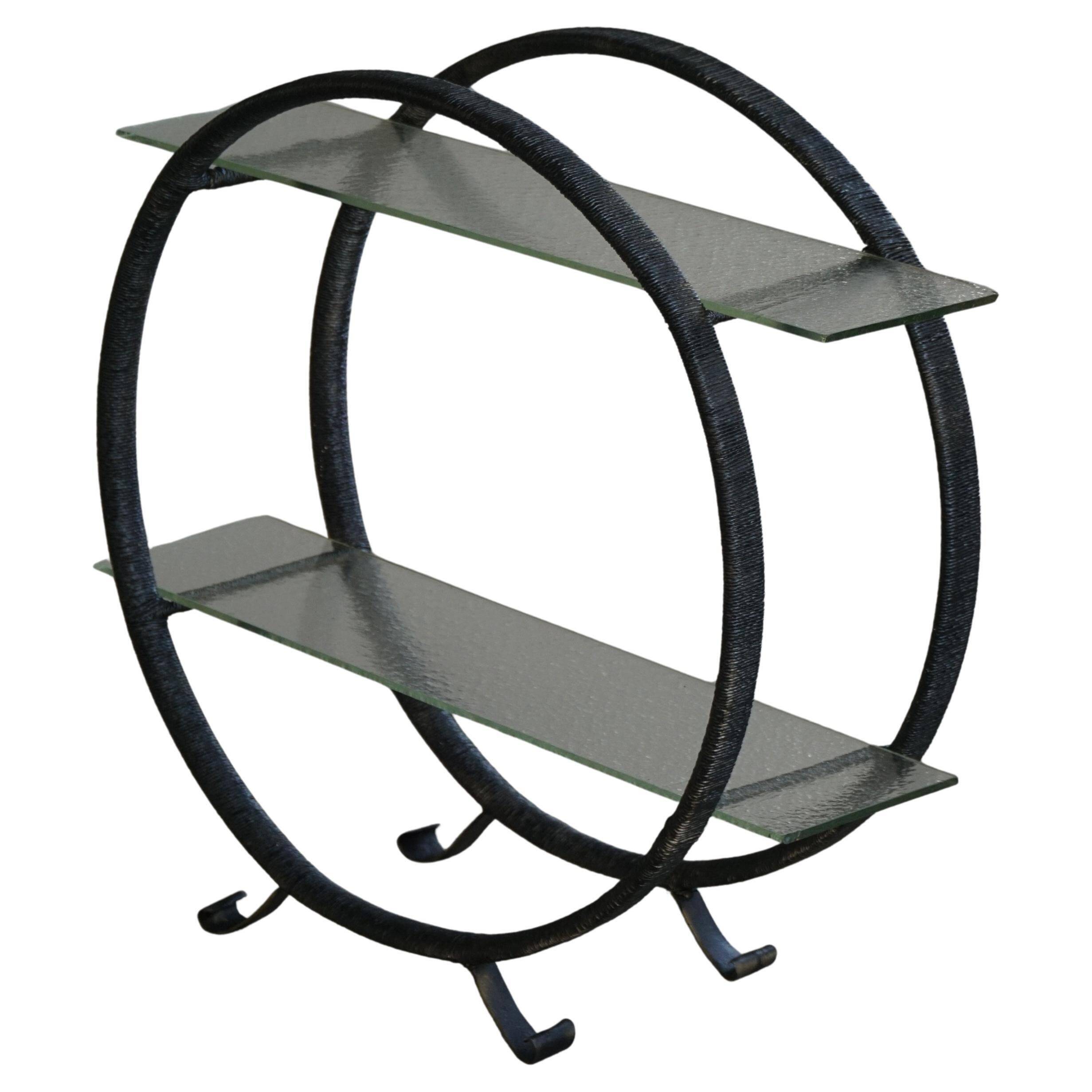 Decorative shelf unit, round metal frames with curved legs and glass shelves, 1960.