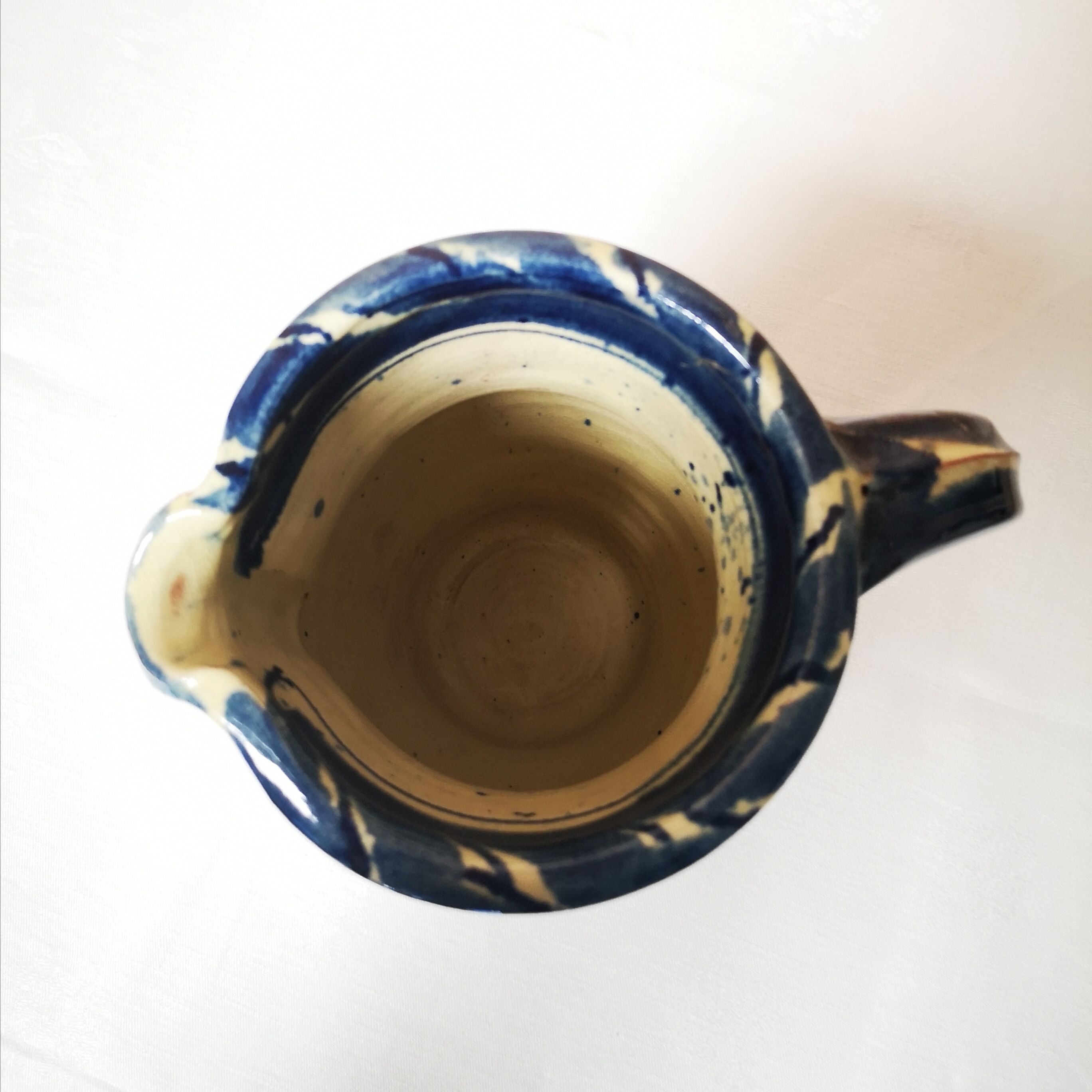 Enamelled ceramic blue pitcher signed by the artist