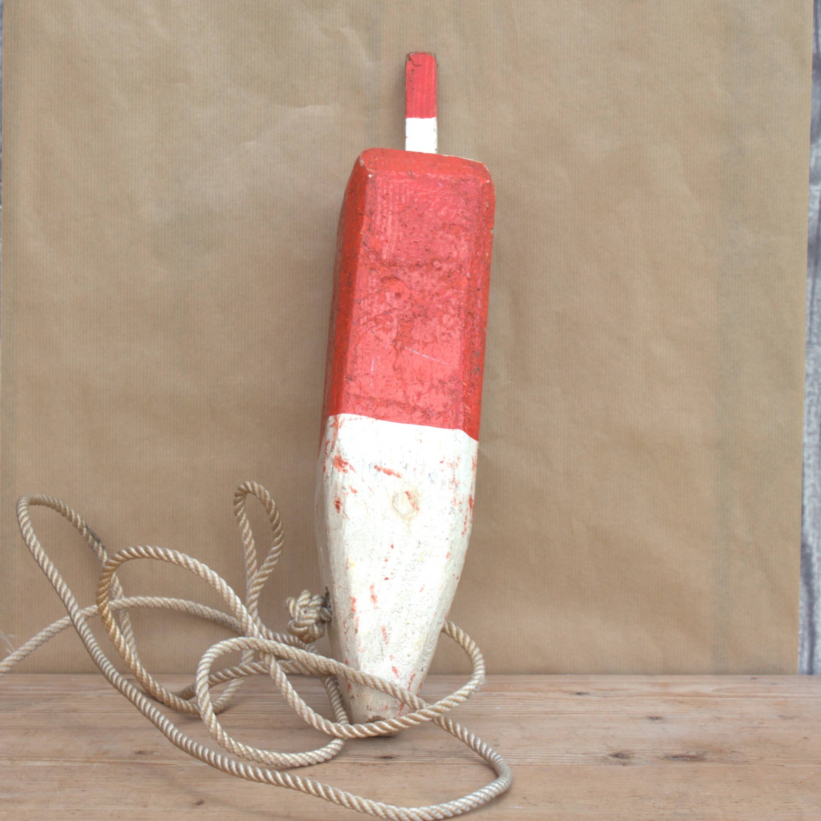 Old red and white wooden buoy
