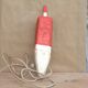 Old red and white wooden buoy