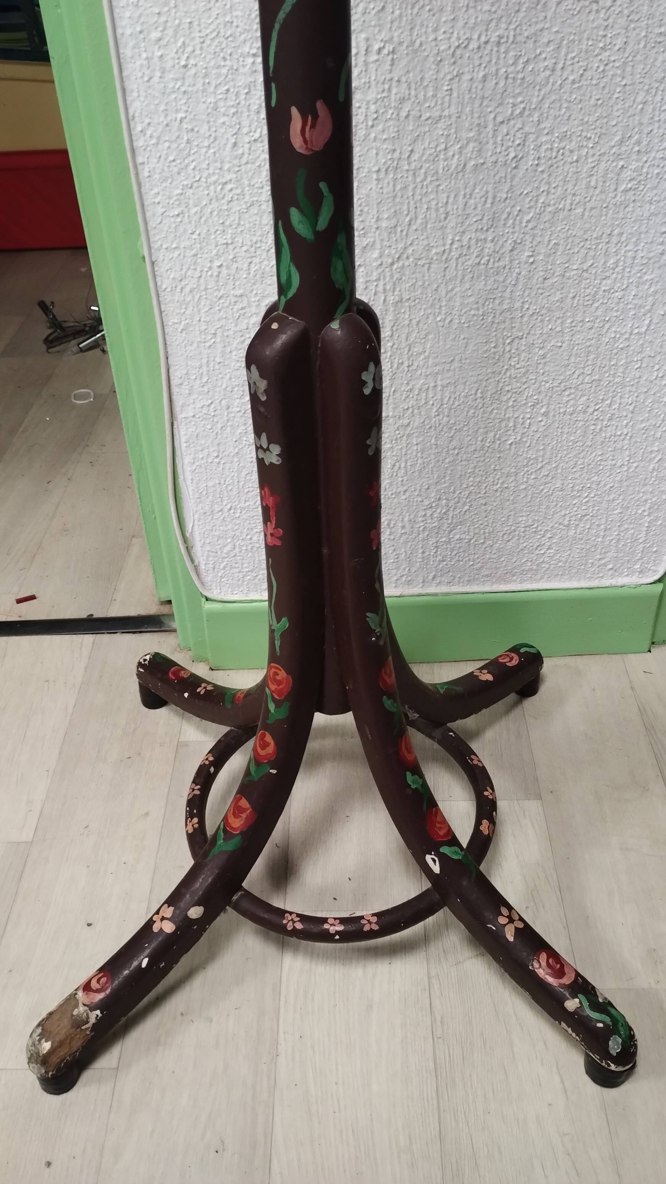 Wooden parrot coat rack with painted floral decoration.