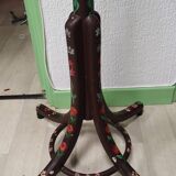 Wooden parrot coat rack with painted floral decoration.