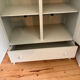 Mint green wardrobe with shelves and hanging space.