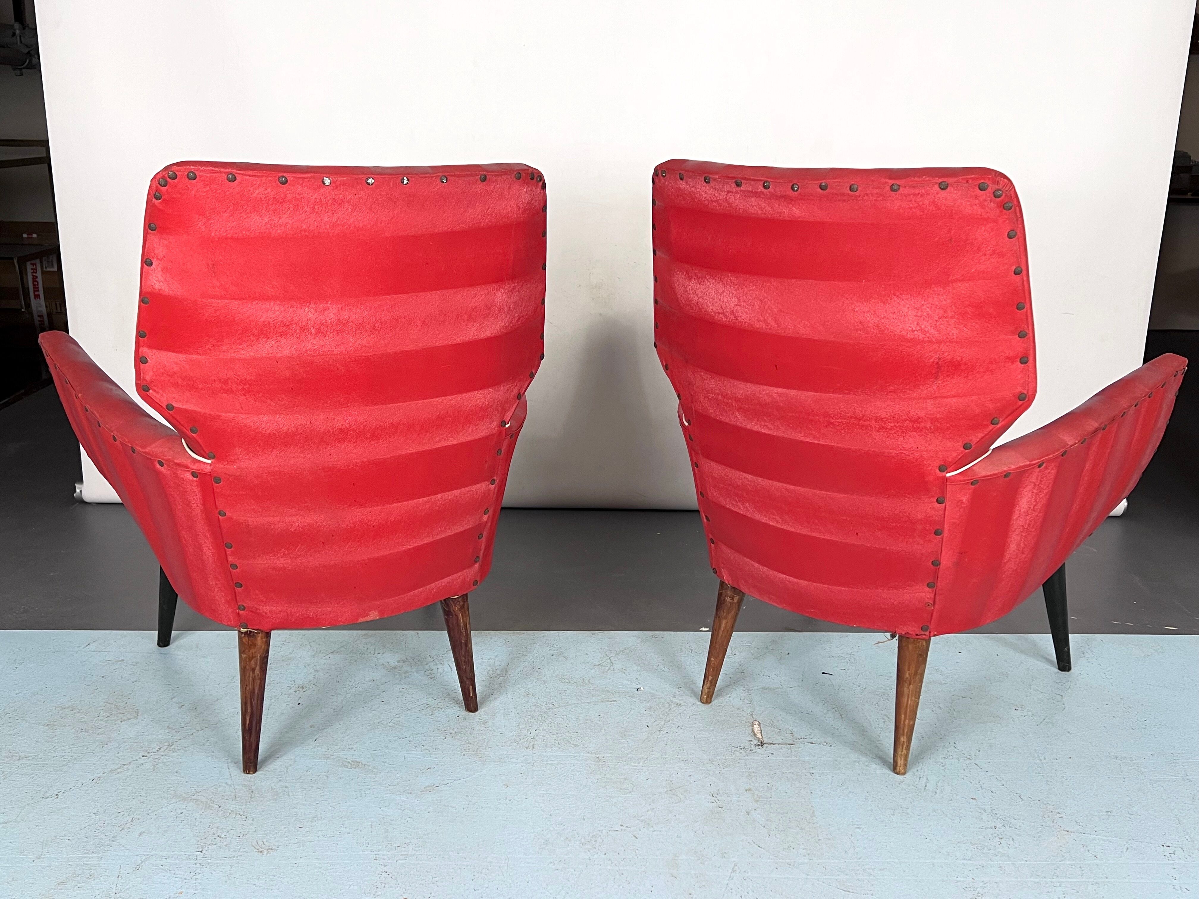 Mid-century modern pair of red armchairs. italy 1950s