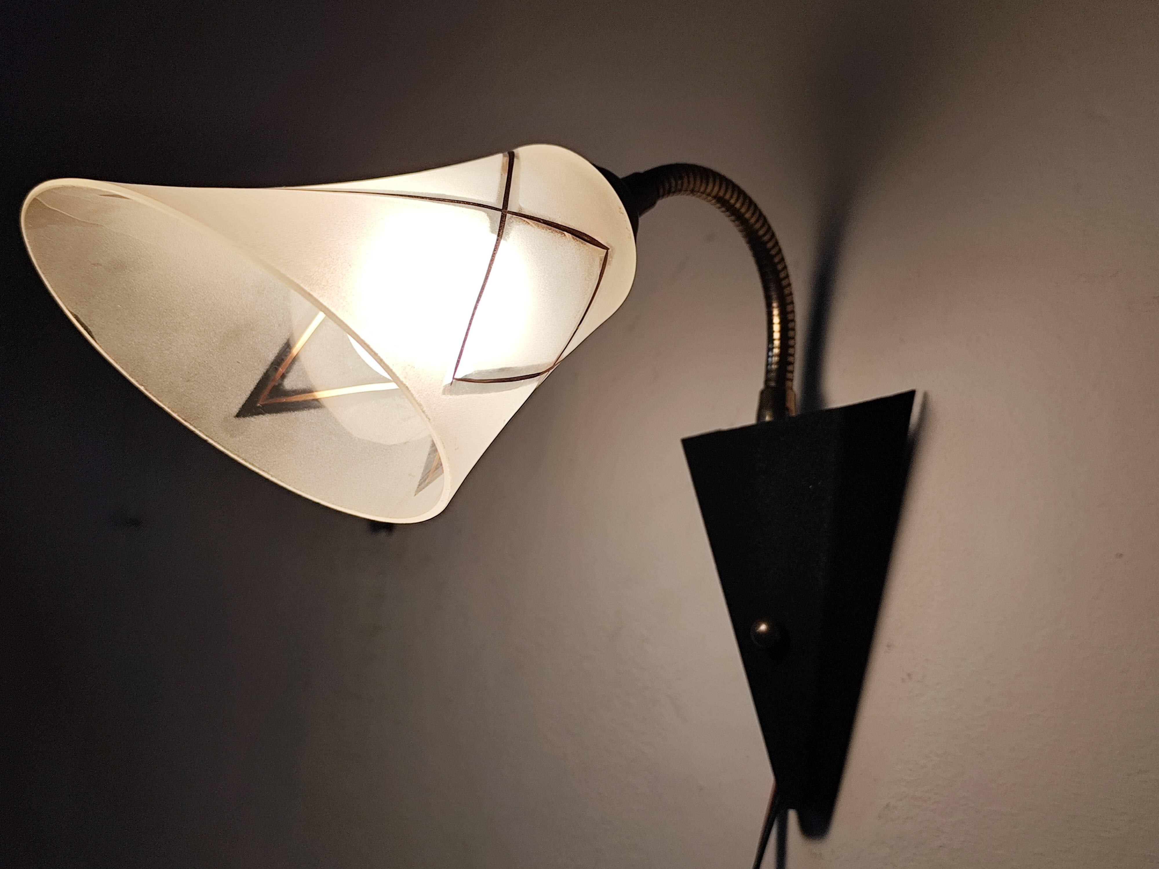 1950s wall lamp, metal, flexible brass stem and opaque shade.