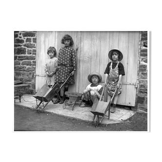 Four children with wheelbarrows