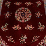 China wool fringed rug with floral pattern on deep plum background 393x274cm