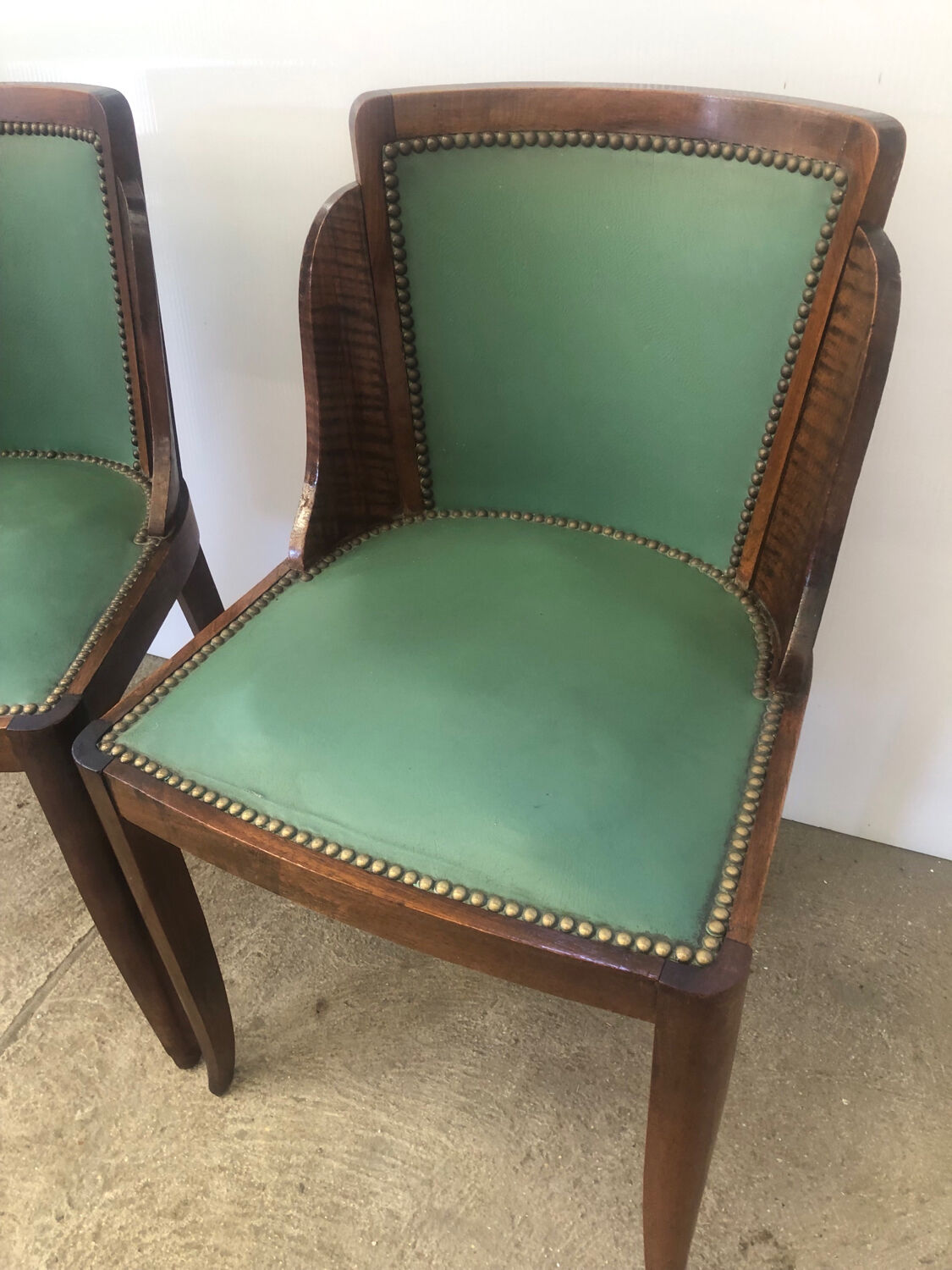 Pair of old wood and green leather gondola chairs