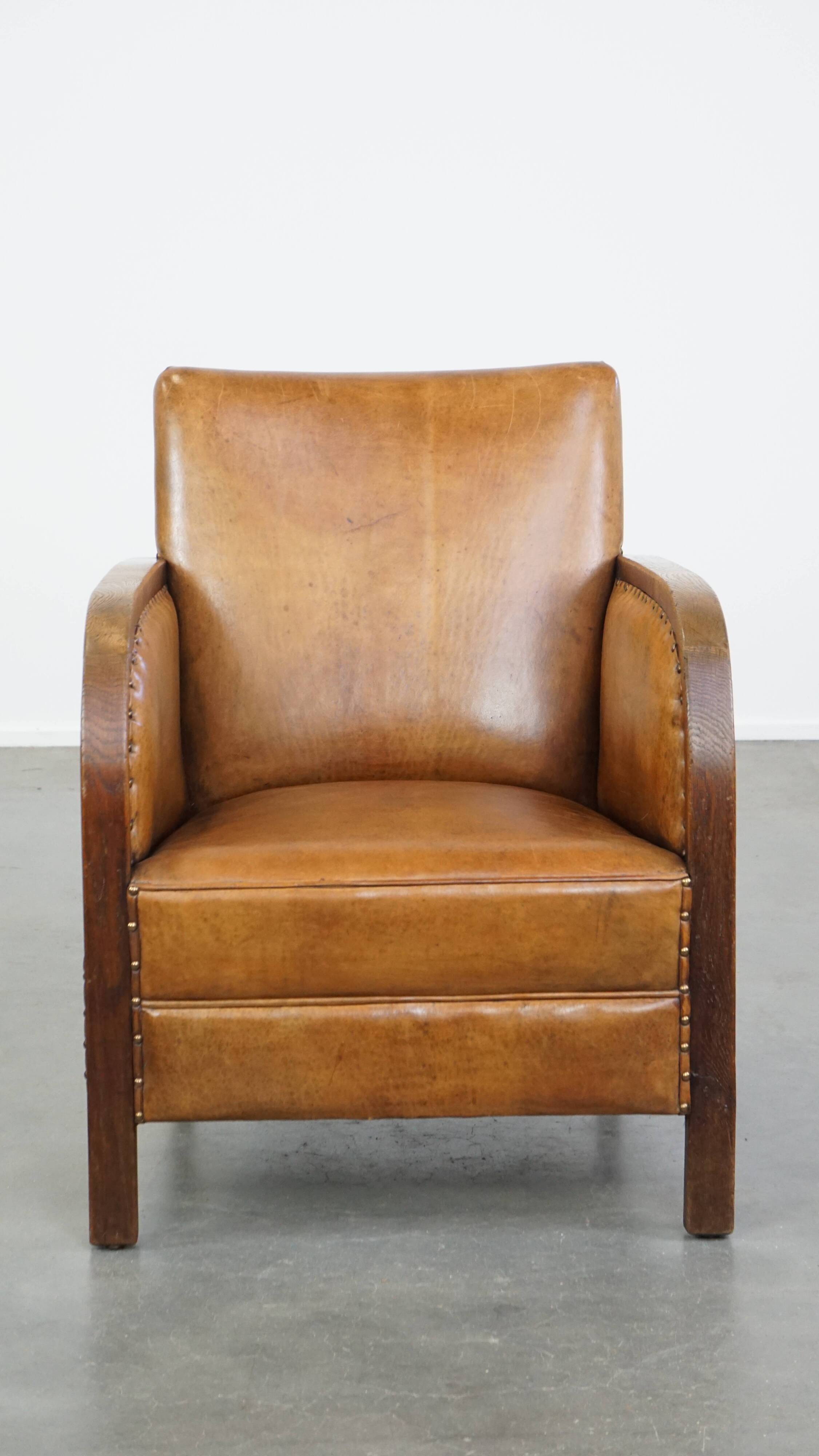 Cognac-colored sheepskin and wooden Art Deco design armchair
