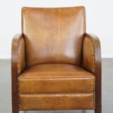 Cognac-colored sheepskin and wooden Art Deco design armchair
