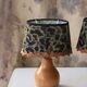 Pair of bedside lamps in pear wood with leopard shade.