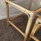 Trio of vintage pull-out tables in rattan and smoked glass 70s