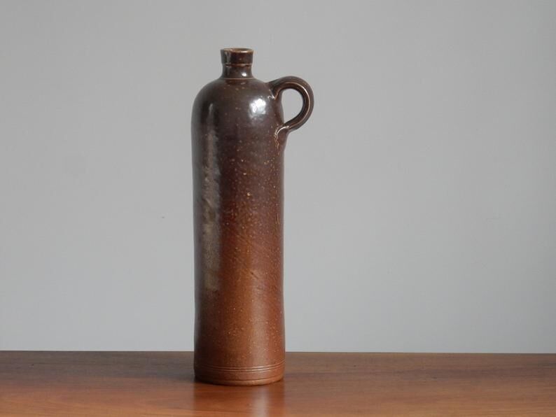 Enamelled brown sandstone bottle with handle