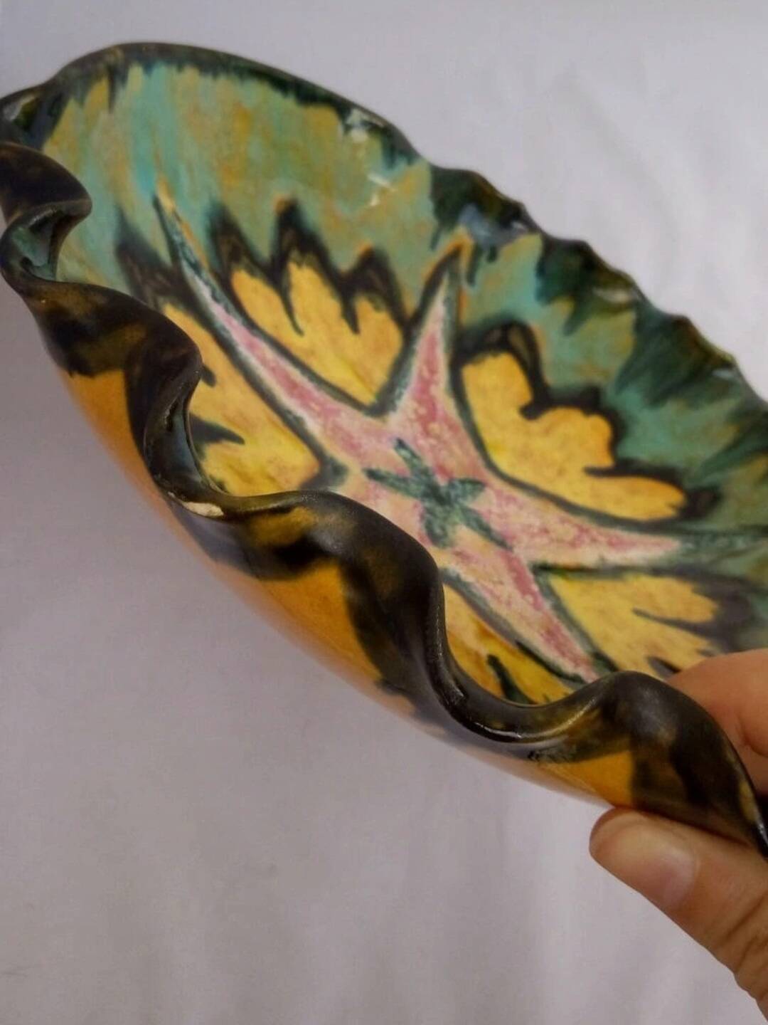 Multicolored earthenware dish signed Yvon Roy