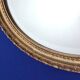 Miroir mural ovale biseauté vintage avec cadre doré vieilli