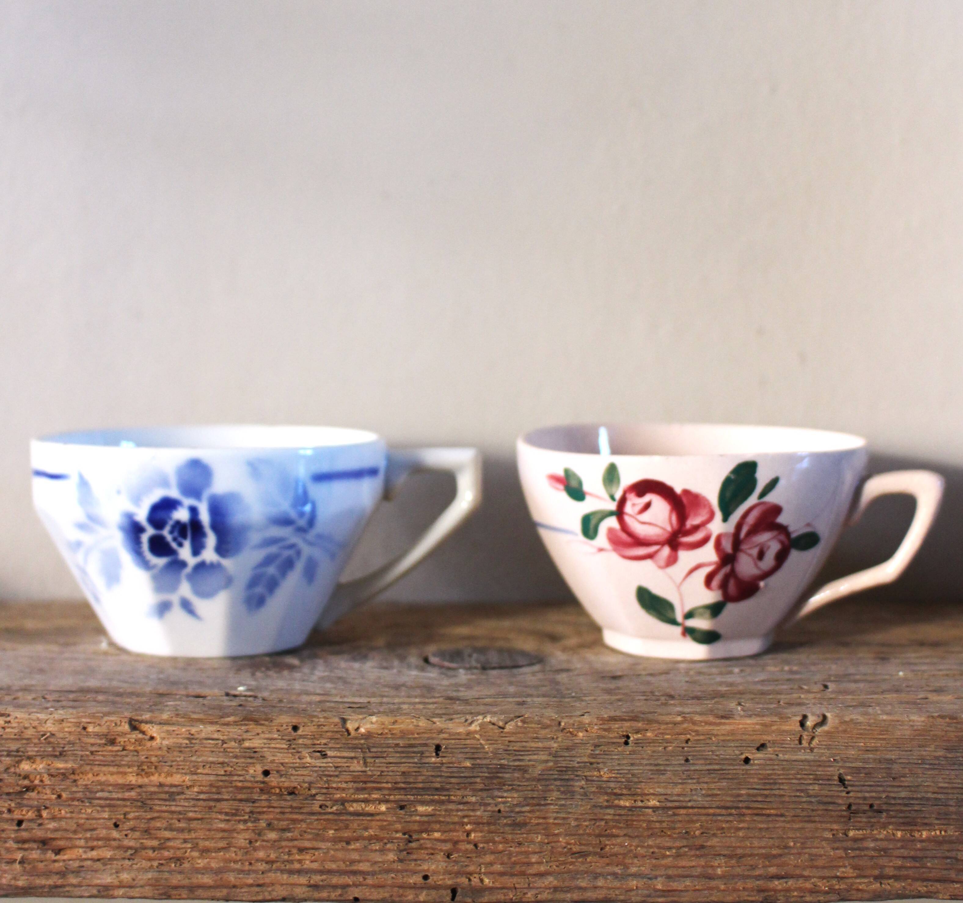 A set of 2 Digoin Sarreguemines cups with pink and blue flowers.