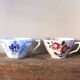 A set of 2 Digoin Sarreguemines cups with pink and blue flowers.