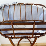 Vintage rattan cradle and its wheeled support