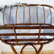 Vintage rattan cradle and its wheeled support