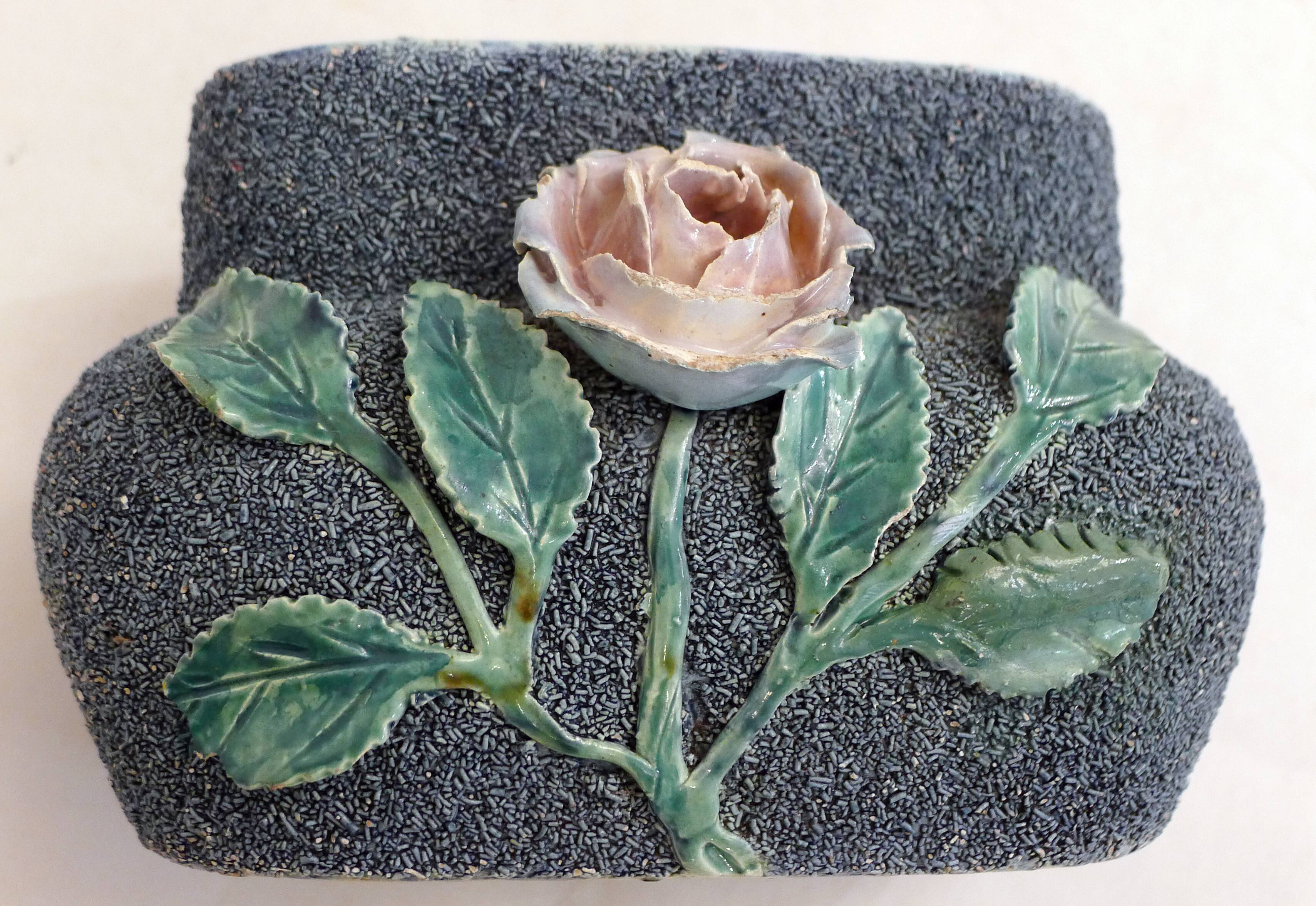 Antique jardinière with rose design in barbotine pottery.