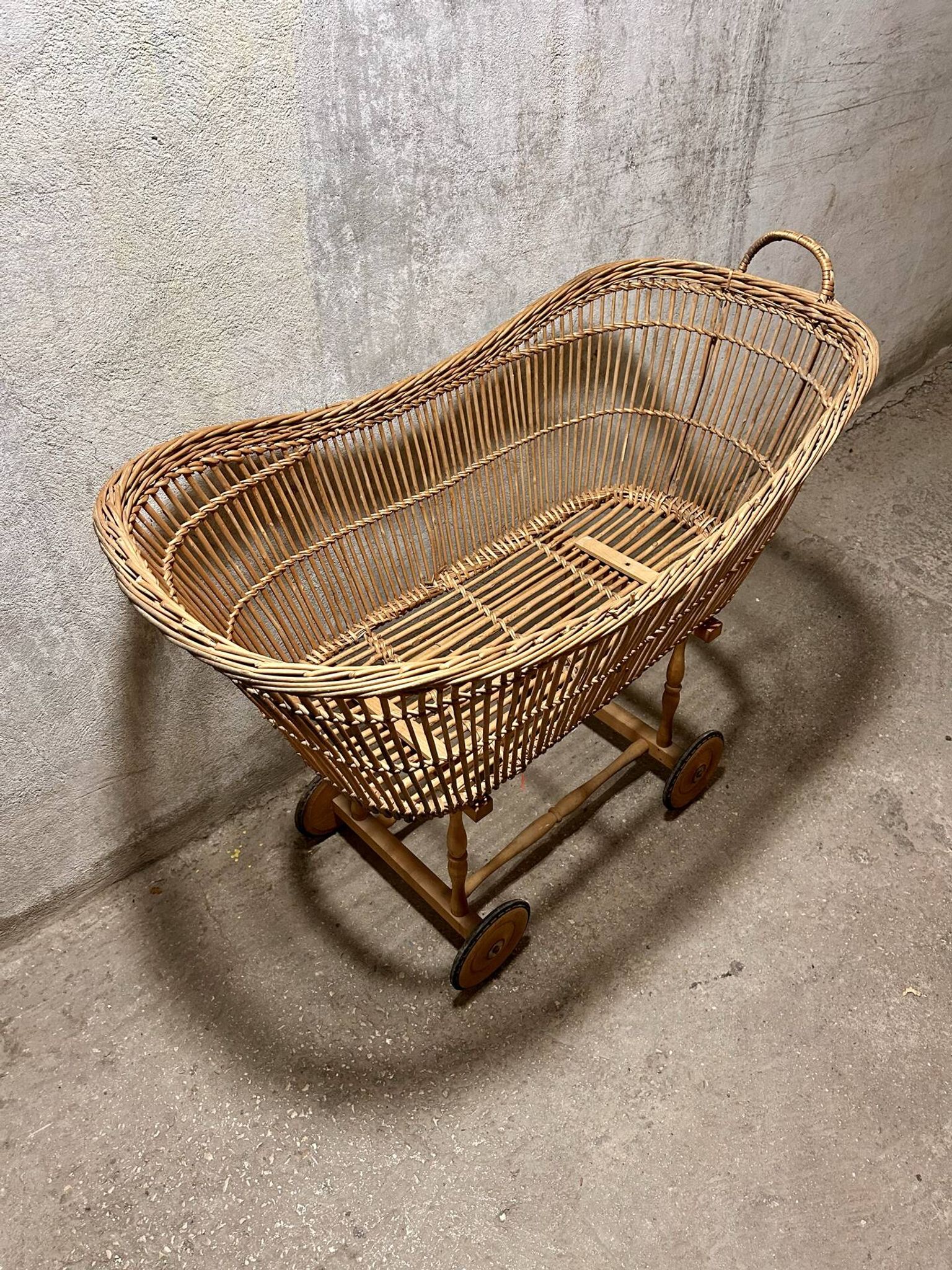 Vintage wicker cradle on wheels