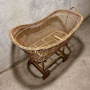 Vintage wicker cradle on wheels
