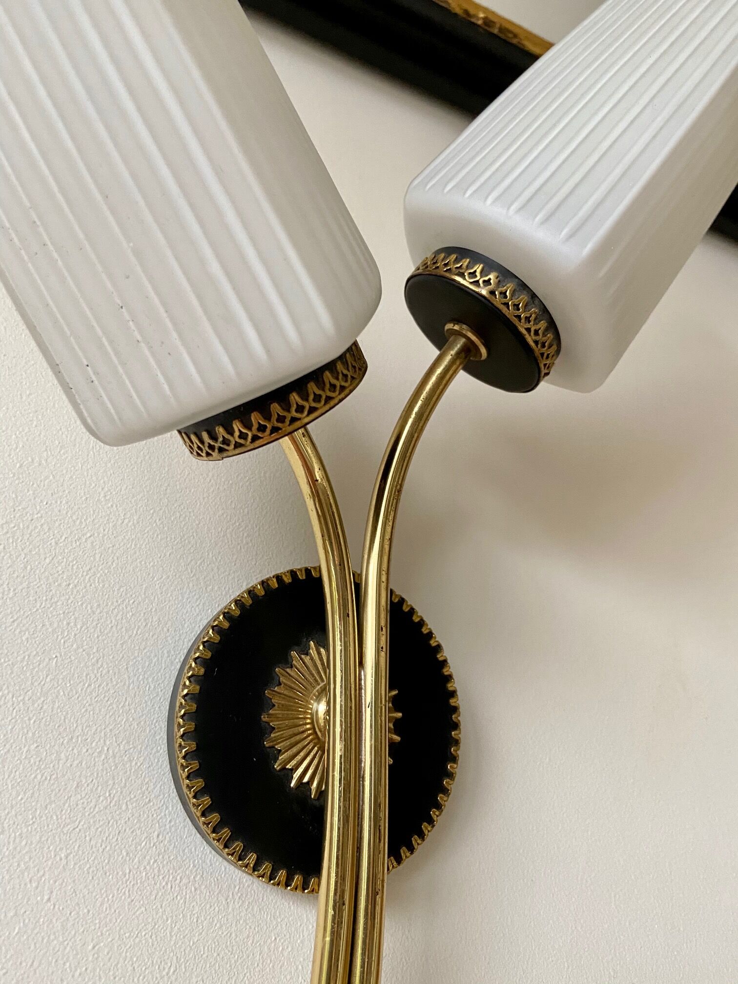 Black and gold metal wall and white opalines sconce