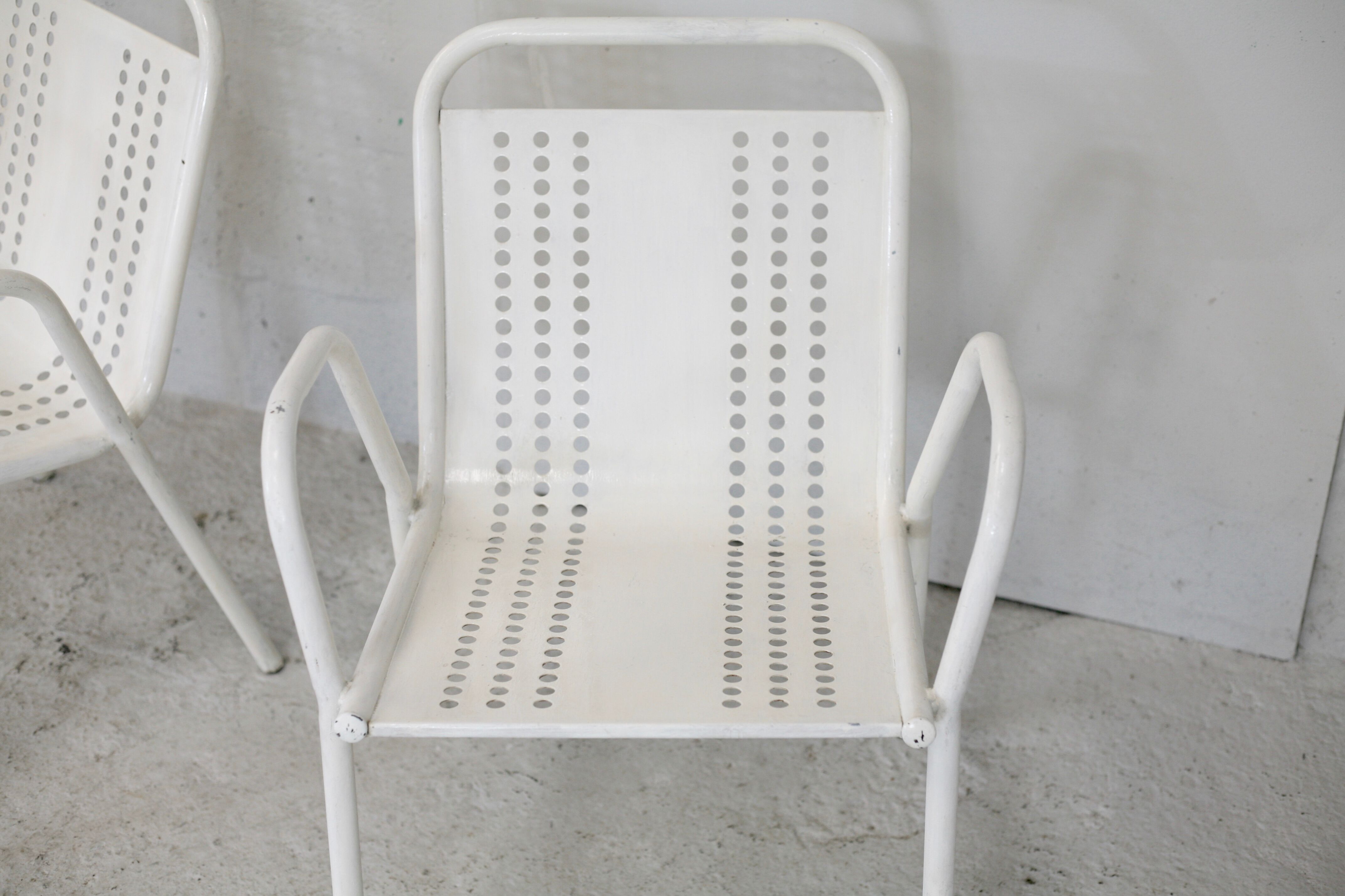 Pair of honeycomb steel armchairs. France, circa 1950.