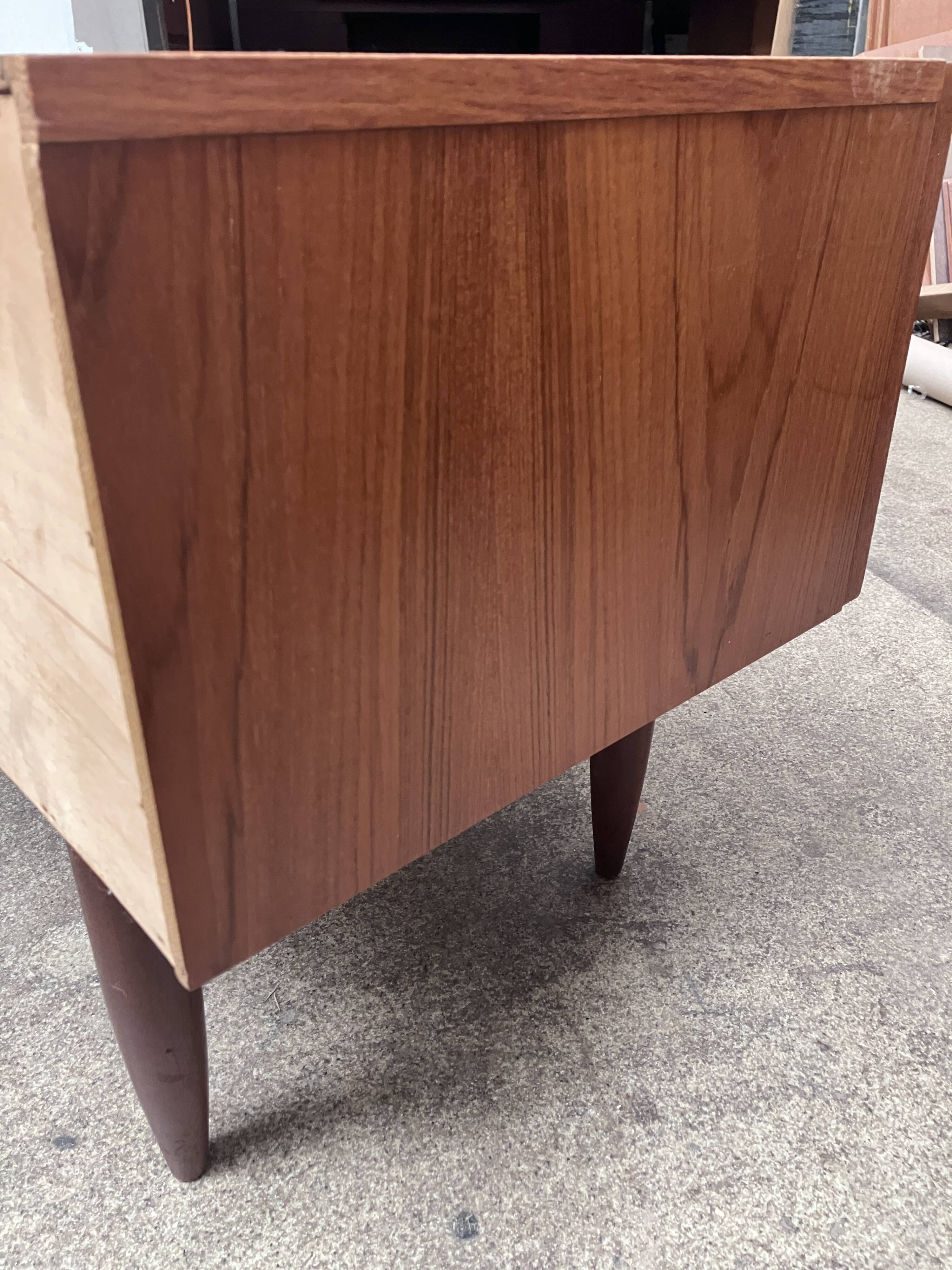 Teak sideboard with flap, 2 drawers and conical legs.