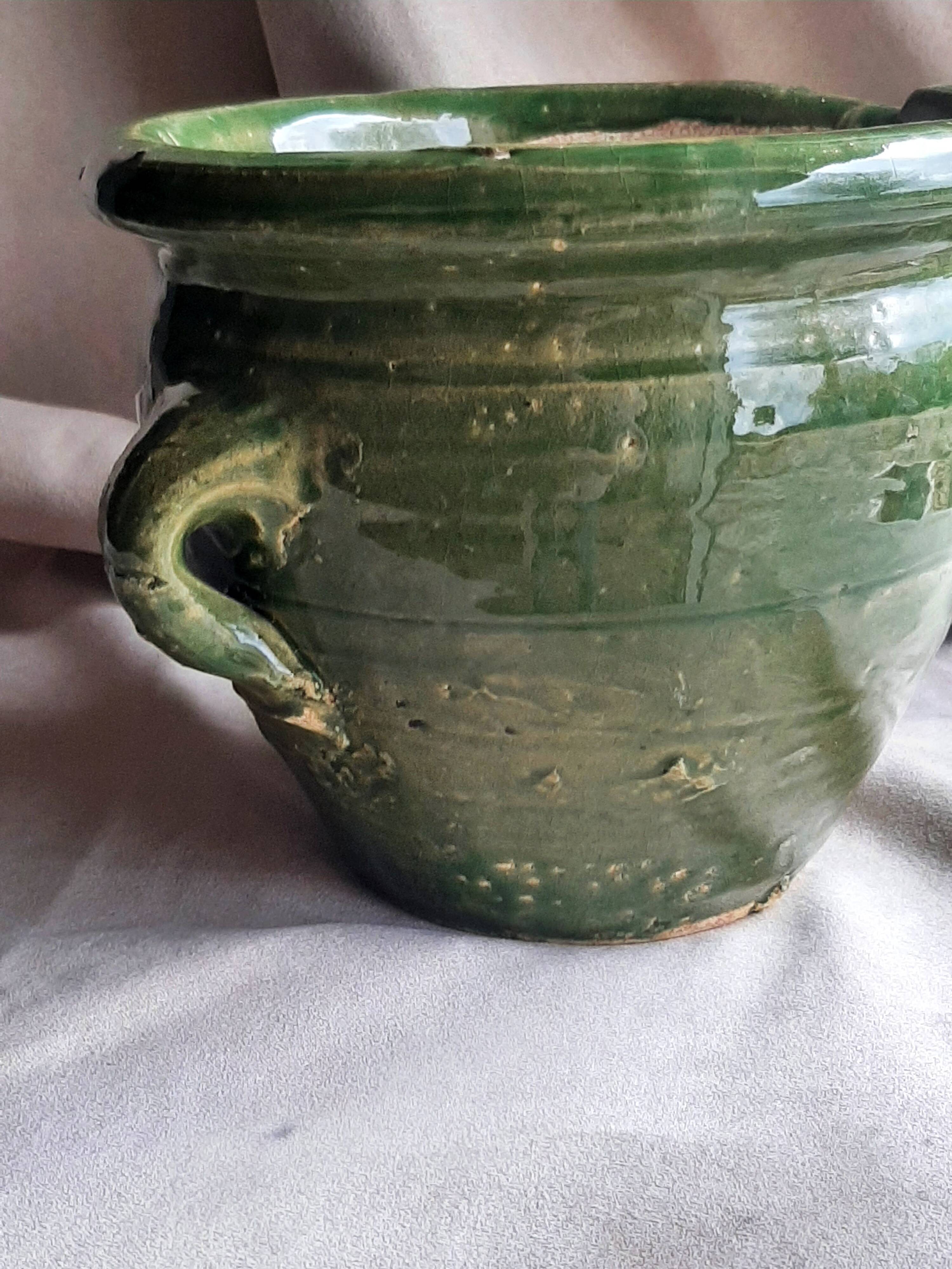 Glazed green terracotta pot.