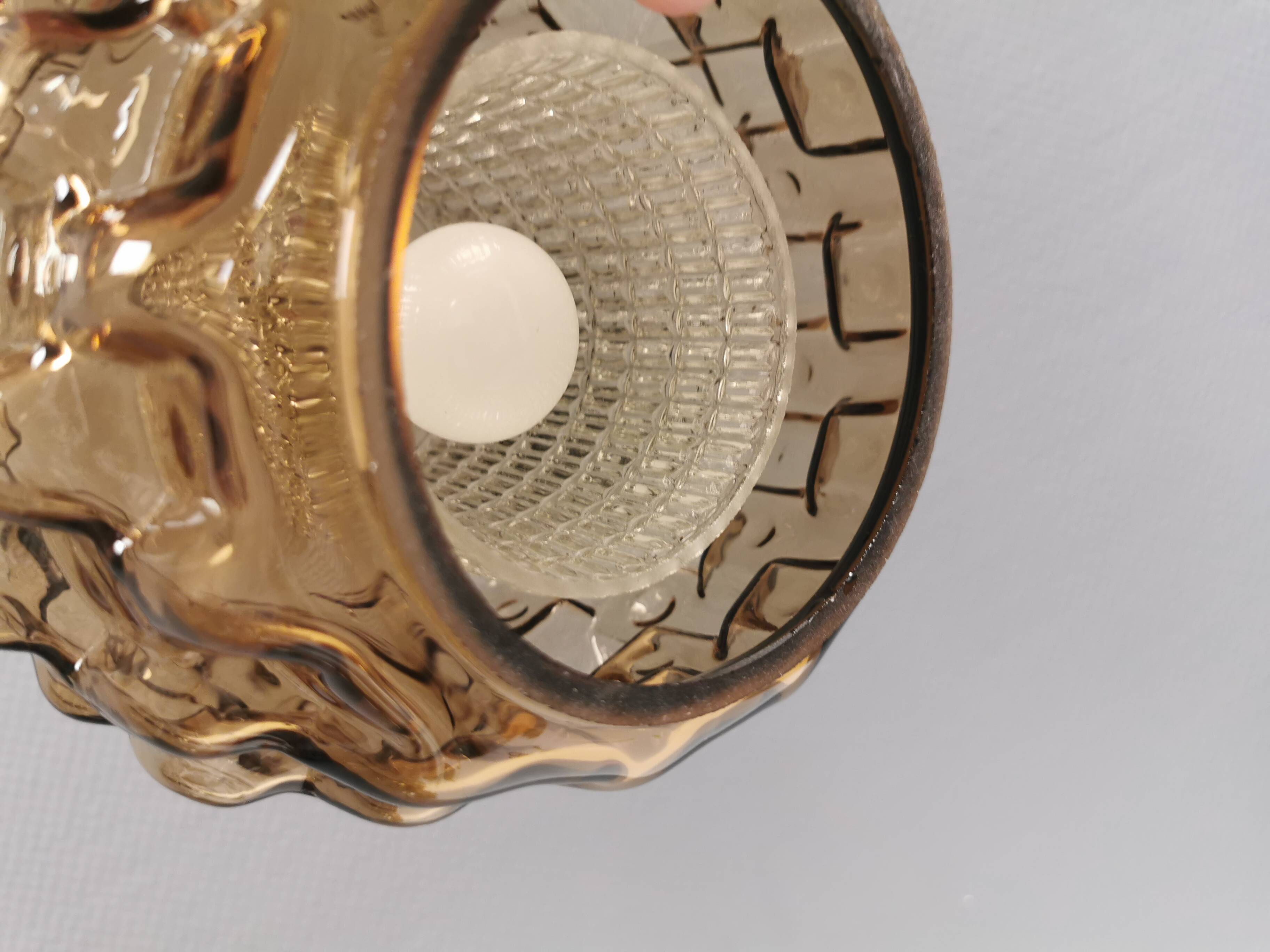 Older hanging lamp with champagne colored outer glass with inner shade of crystal glass.