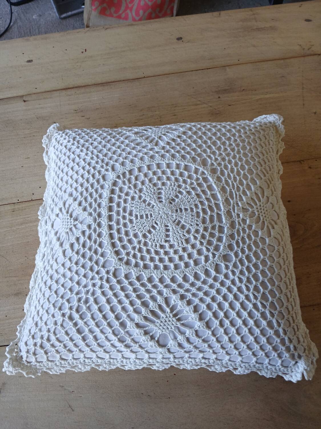 Cushion with white crochet cover