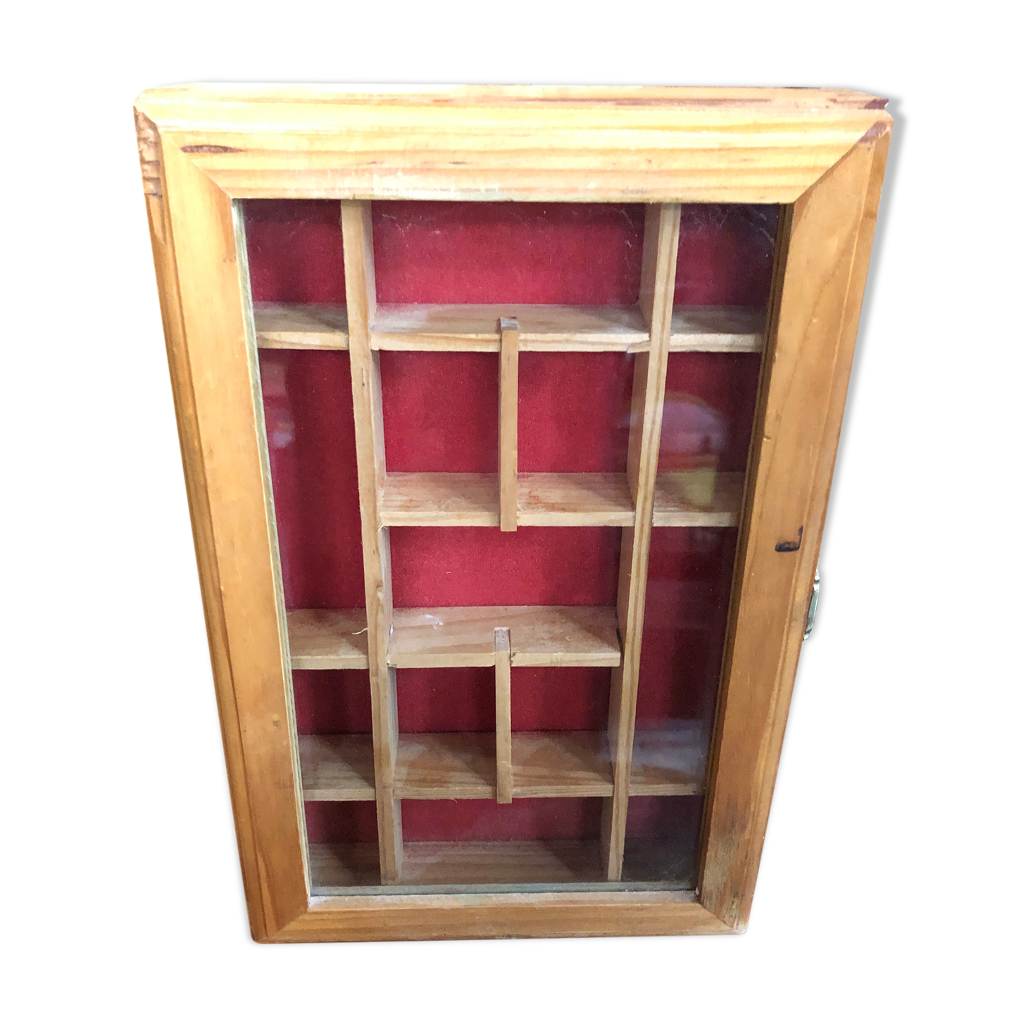 Old hanging display case with 15 wooden boxes, red background + vintage glass door