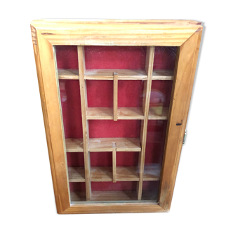 Old hanging display case with 15 wooden boxes, red background + vintage glass door