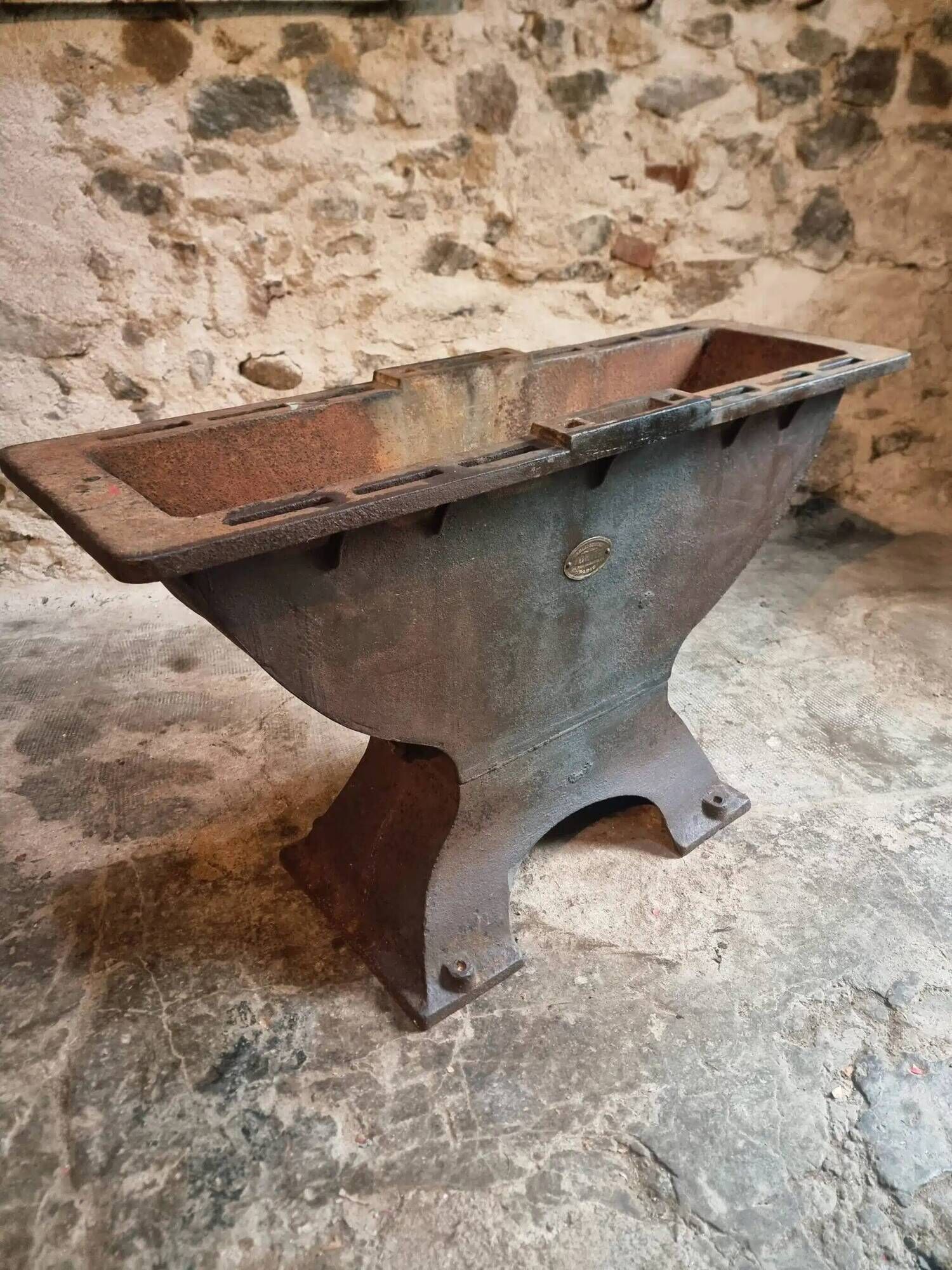 Old French industrial table with a cast iron base and a pine top.