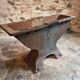 Old French industrial table with a cast iron base and a pine top.