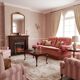Vintage pink two-seater sofa with fringes