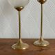 Pair of tulip-shaped candle holders in frosted glass and brass.