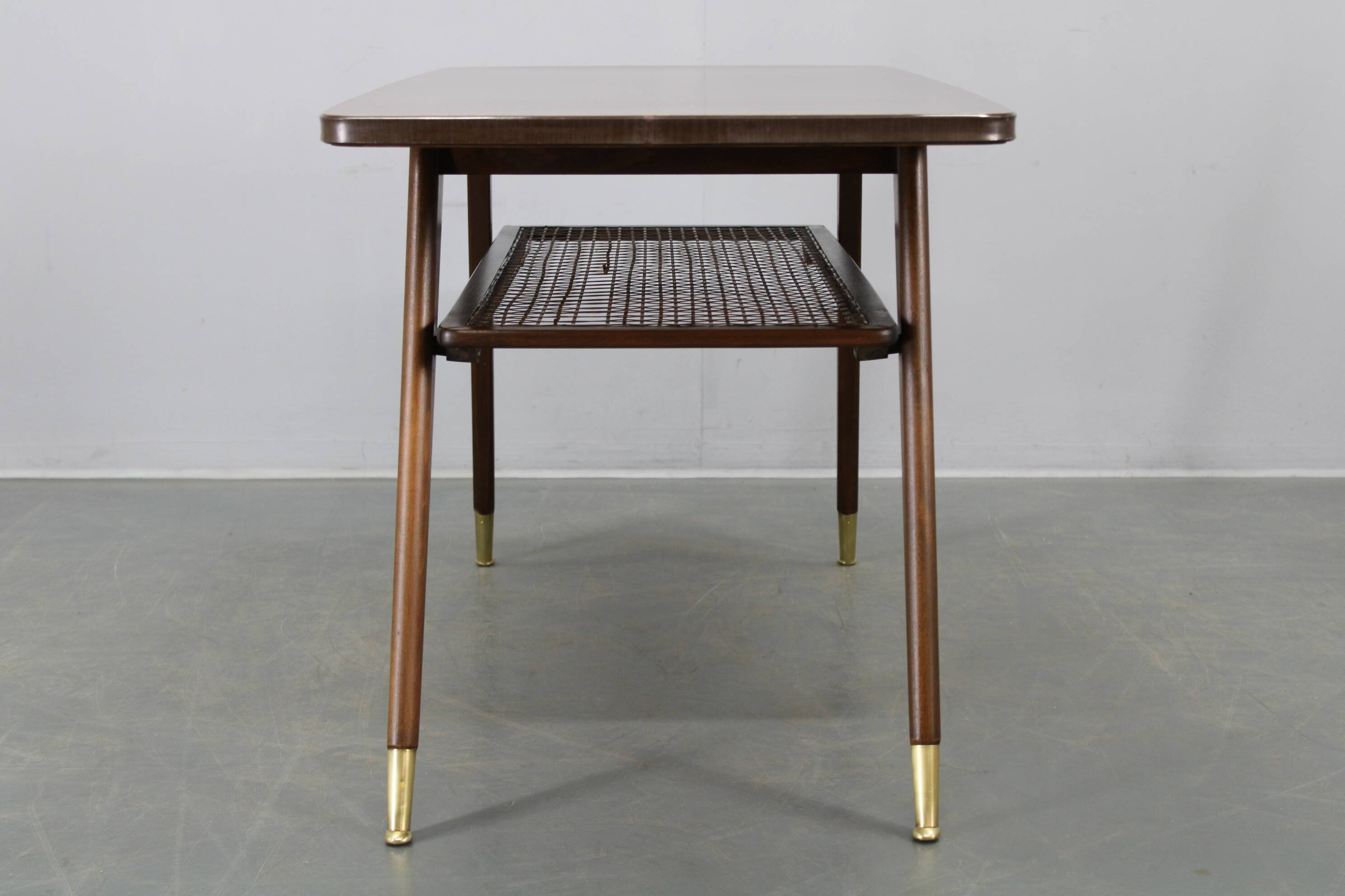 Mid-century German coffee table with rattan shelf and brass legs
