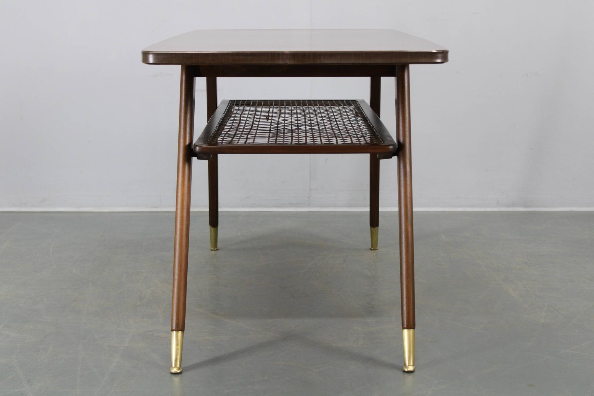 Mid-century German coffee table with rattan shelf and brass legs
