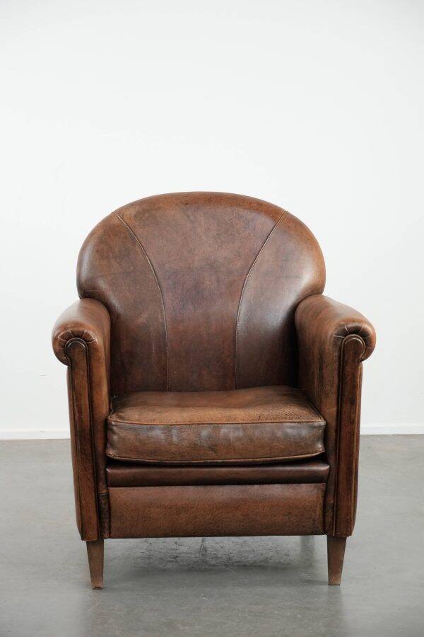 Beautiful vintage sheep leather armchair with a characterful appearance