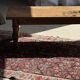 Brown Indonesian teak coffee table, with a border and cylindrical legs H40 L103.