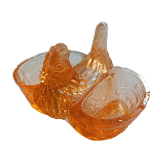 Old pink moulded glass salt shaker in the shape of a hen