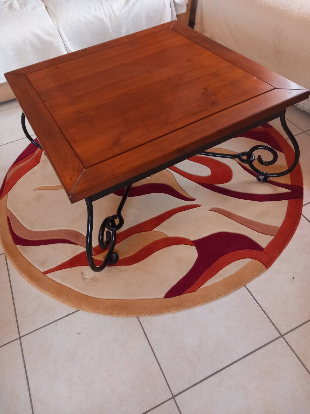 Coffee table in cherry wood with a wrought iron base.