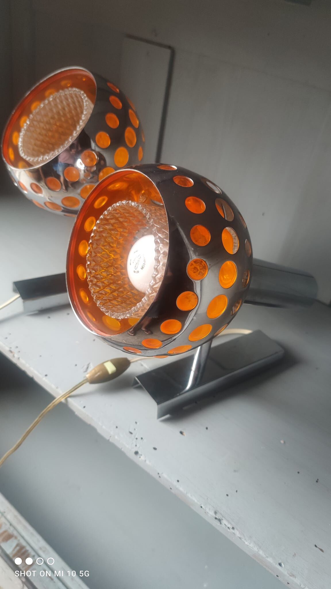 Pair of chrome-plated metal wall lights with adjustable ball joints, circa 1970